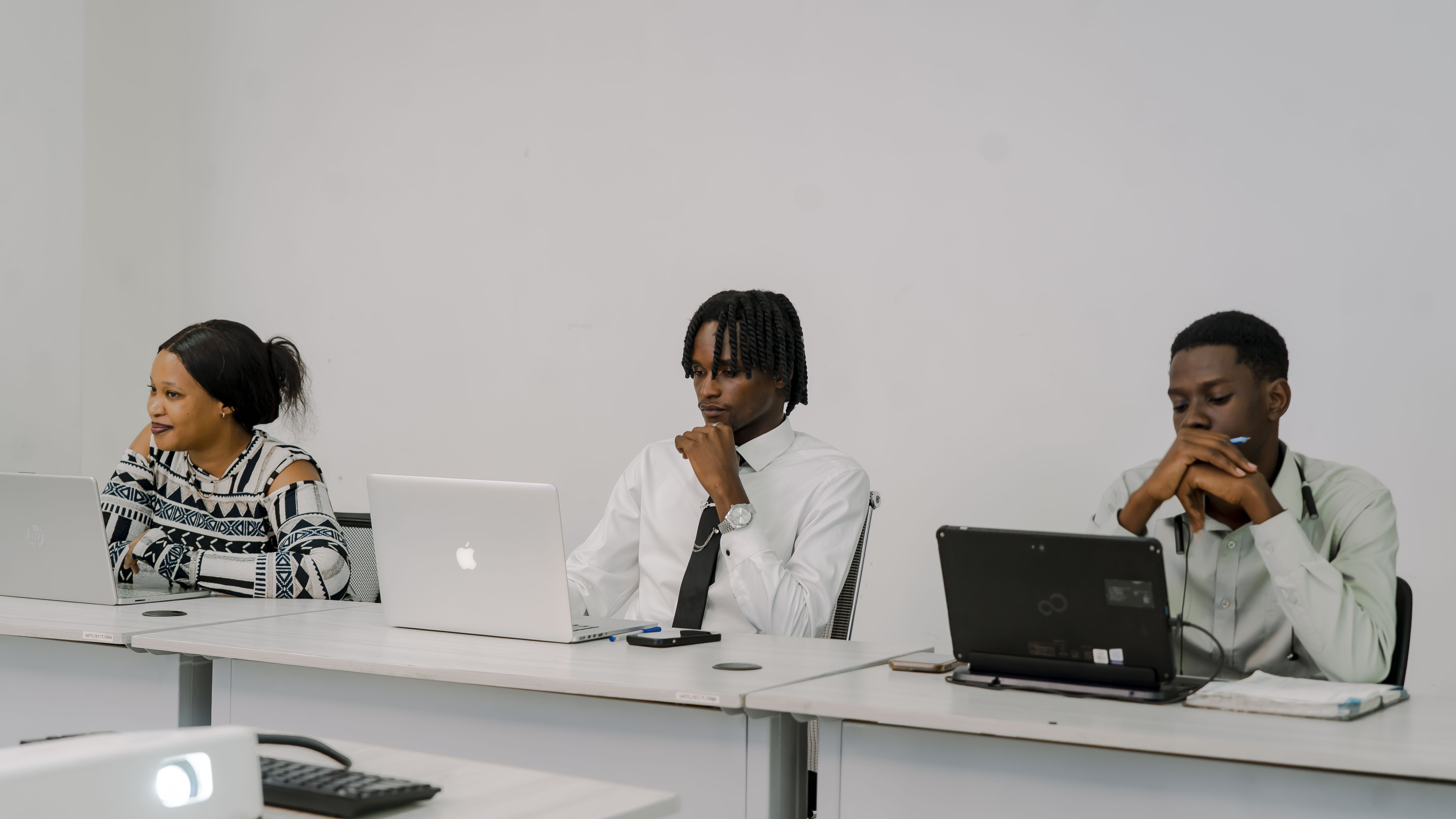 Trainees focused on their laptops during a Soma session