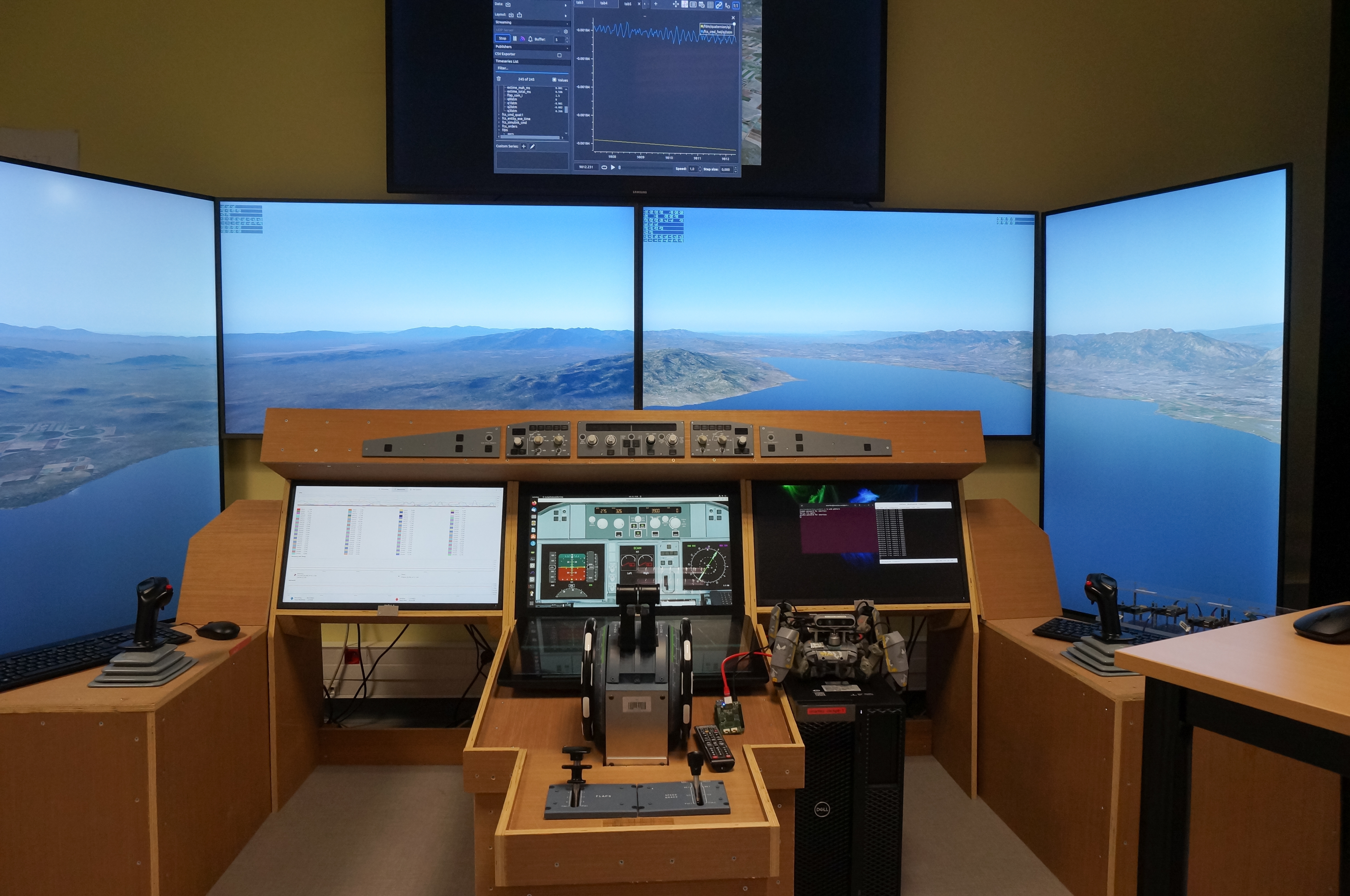 A flight-simulator setup with cockpit controls and wraparound displays